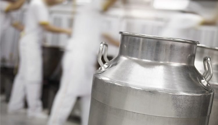 milk container in the foreground in a dairy factory;